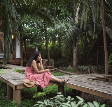 Young Asian woman relax in forest, Beautiful female happy using